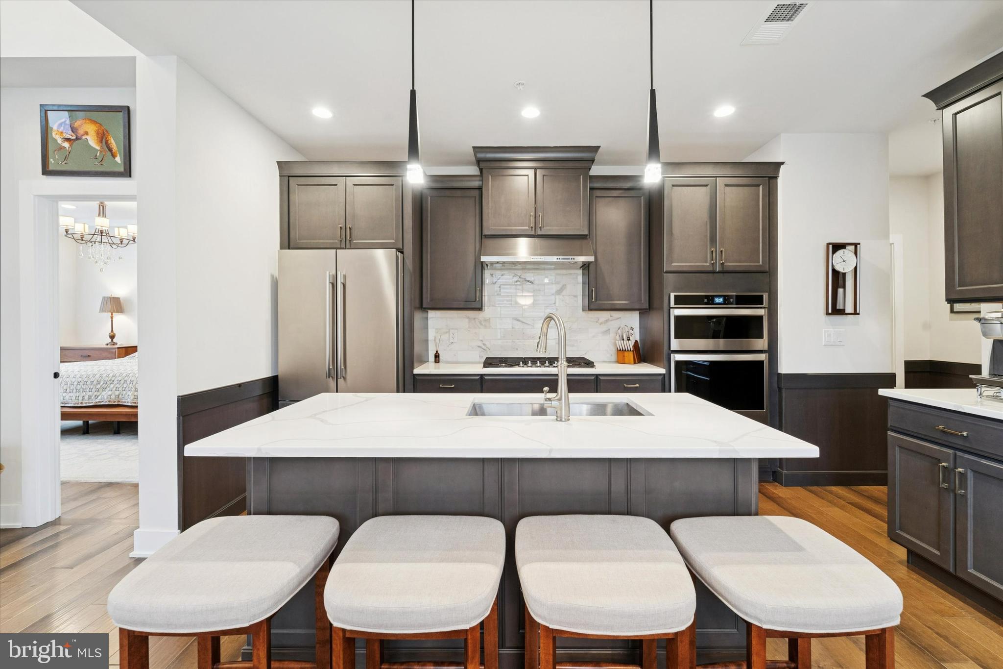 658 Levering Street Blue Bell, PA 19422 - Photo 9 of 38 a kitchen with a dining table chairs and refrigerator
