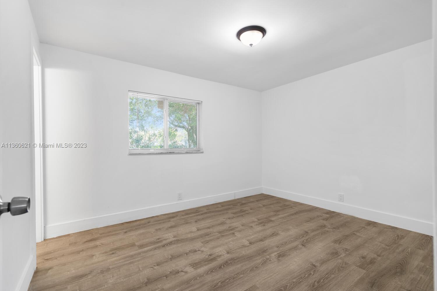 611 Davis Road Delray Beach, FL 33445 - Photo 14 of 22 an empty room with a workbench