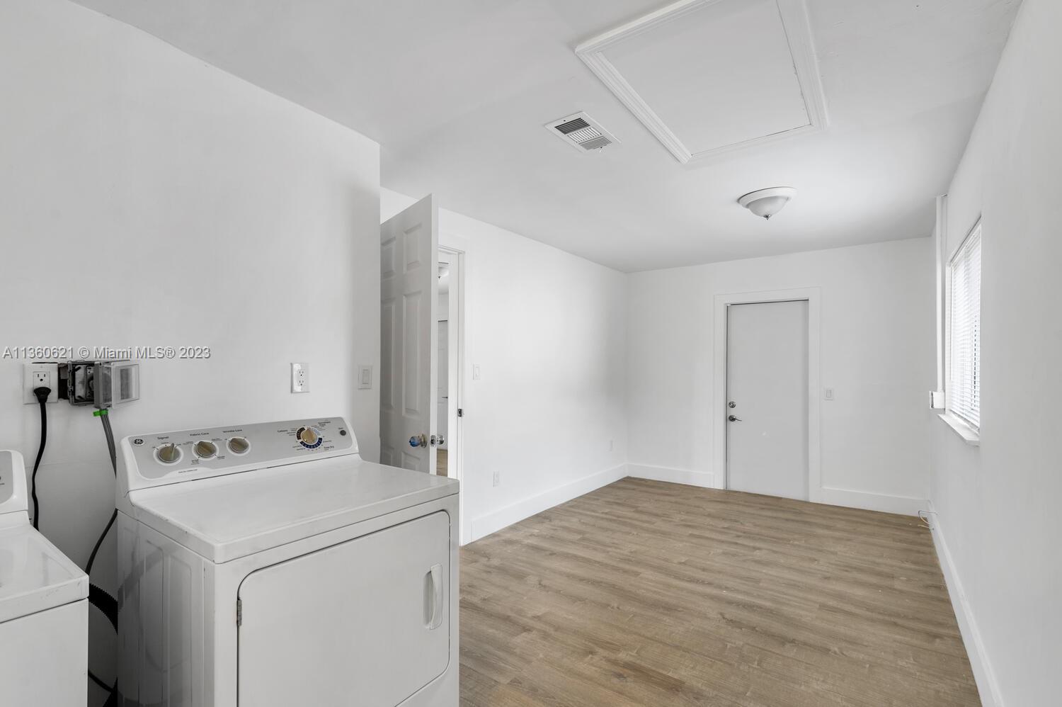 611 Davis Road Delray Beach, FL 33445 - Photo 18 of 22 a utility room with dryer and washer