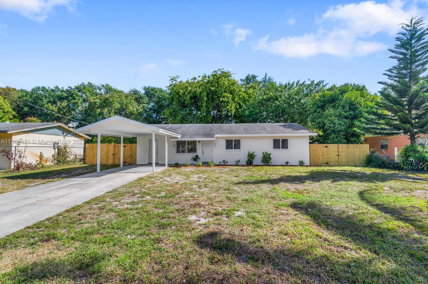 611 Davis Road Delray Beach, FL 33445 - Photo 19 of 22 a front view of a house with garden