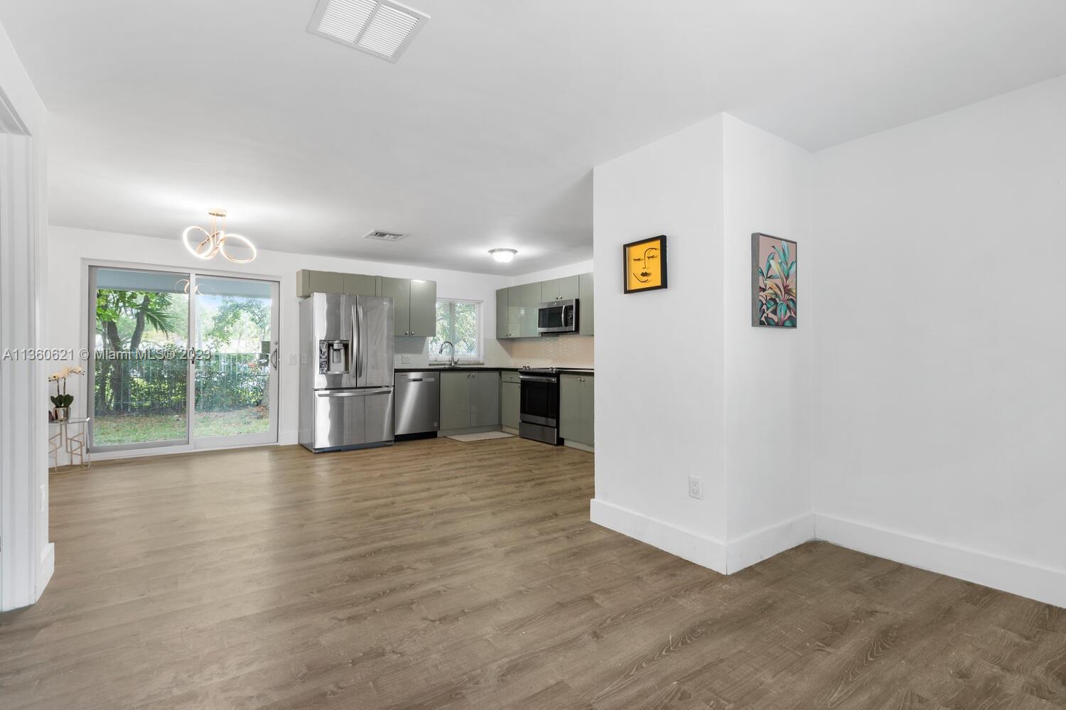 611 Davis Road Delray Beach, FL 33445 - Photo 4 of 22 a view of kitchen with furniture and wooden floor