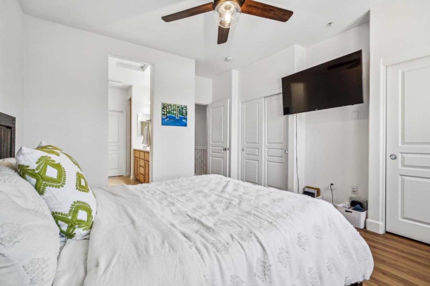 25478 Huntwood Avenue Hayward, CA 94544 - Photo 23 of 35 a bedroom with a bed a flat tv screen and a chandelier