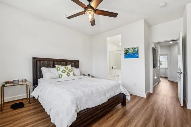 a bedroom with a bed and ceiling fan