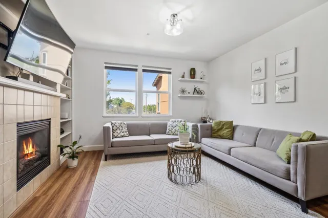 a living room with furniture and a fireplace
