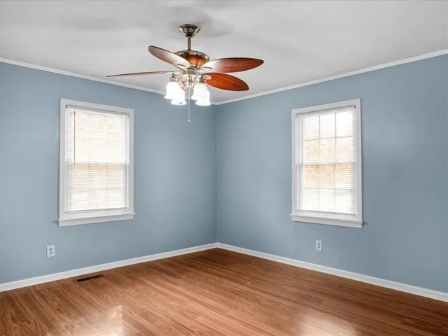 a view of room with window and wooden floor