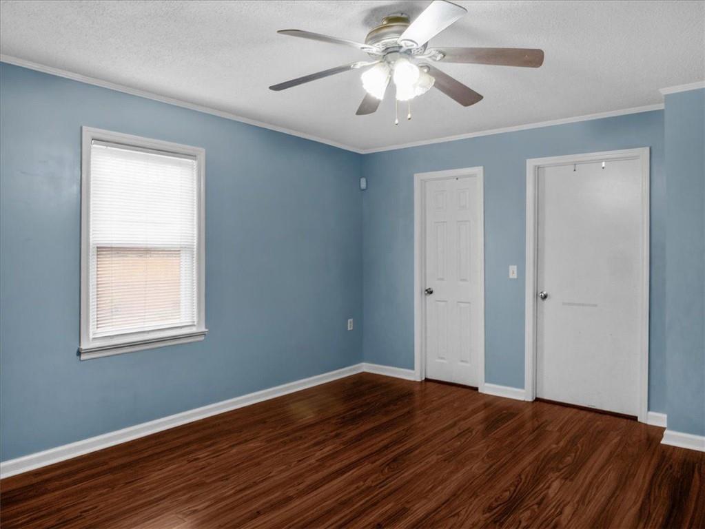 1115 Ila Road Commerce, GA 30530 - Photo 24 of 38 a view of empty room with wooden floor and fan