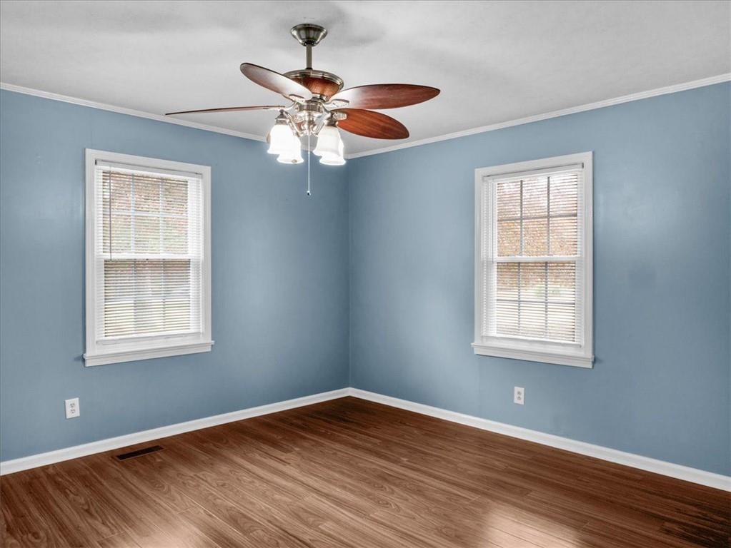 1115 Ila Road Commerce, GA 30530 - Photo 26 of 38 a view of an empty room with wooden floor and a window