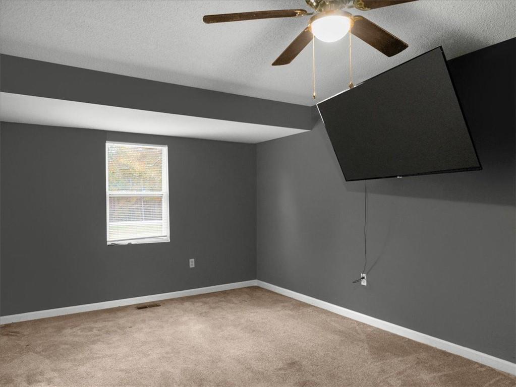 1115 Ila Road Commerce, GA 30530 - Photo 28 of 38 a view of an empty room with window and chandelier fan
