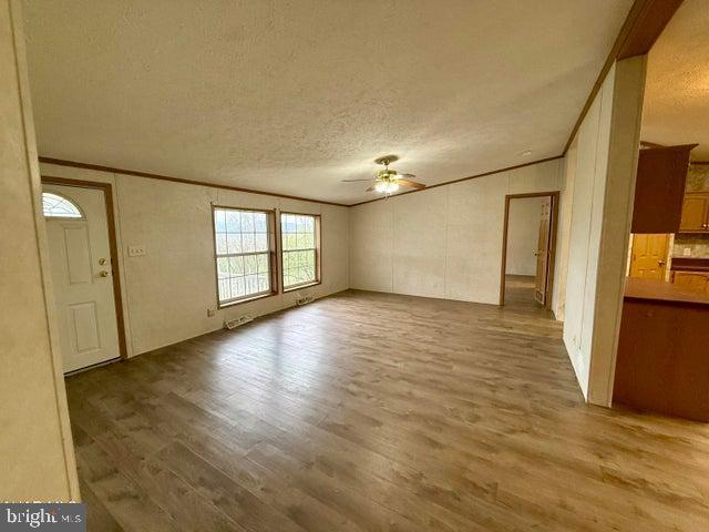 192 Northern Pine Road Hopewell, PA 16650 - Photo 12 of 66 a view of empty room with wooden floor and fan