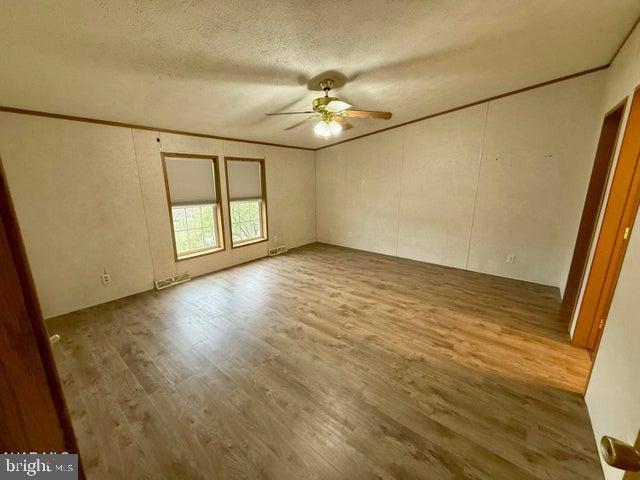 192 Northern Pine Road Hopewell, PA 16650 - Photo 14 of 66 an empty room with wooden floor fan and windows