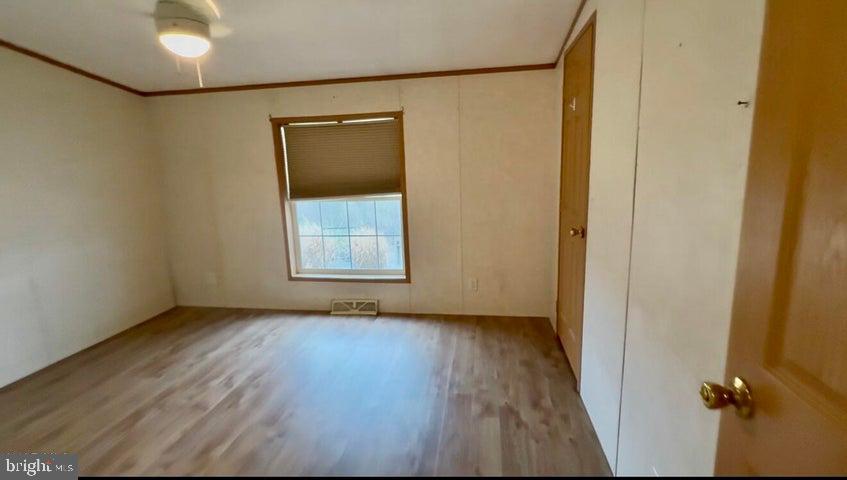 192 Northern Pine Road Hopewell, PA 16650 - Photo 28 of 66 an empty room with wooden floor and windows