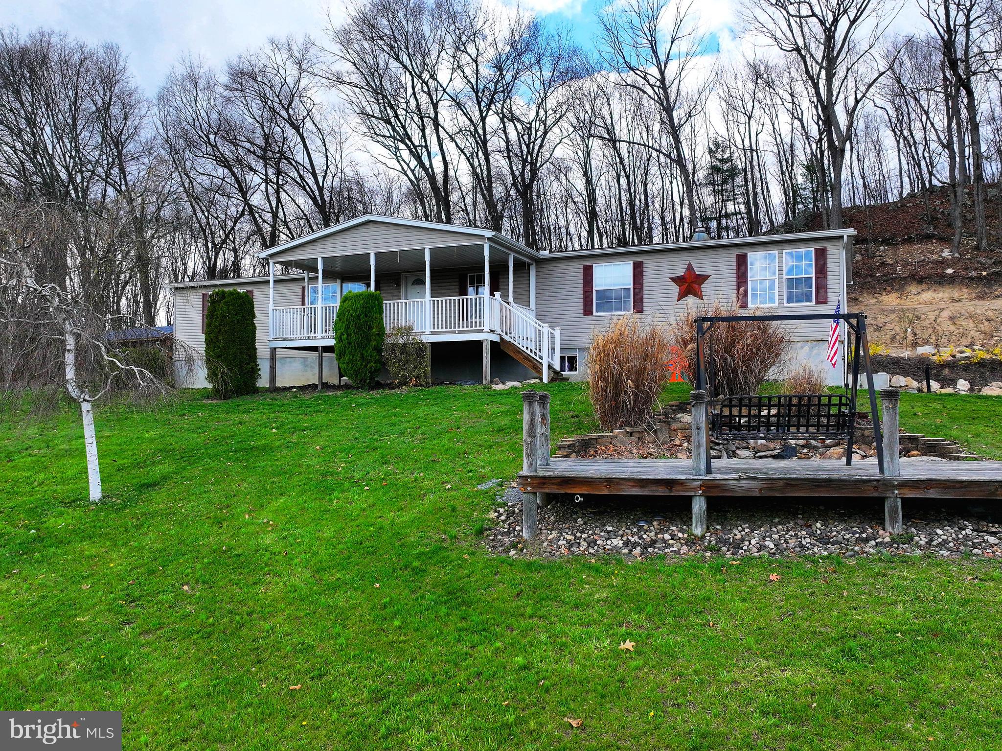 192 Northern Pine Road Hopewell, PA 16650 - Photo 54 of 66 a front view of a house with a yard table and chairs