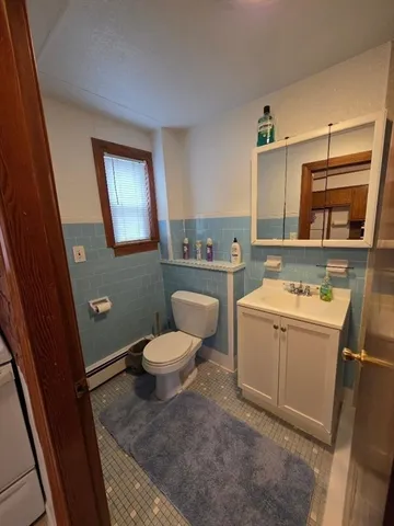 a bathroom with a sink a toilet and mirror