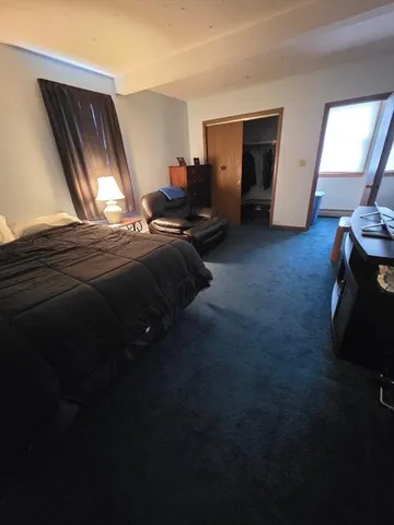 a bed sitting in a room next to a window