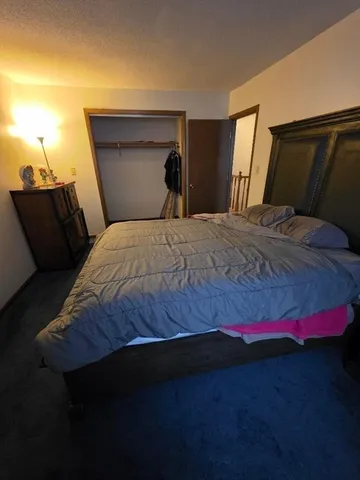 a bedroom with a bed and a night stand