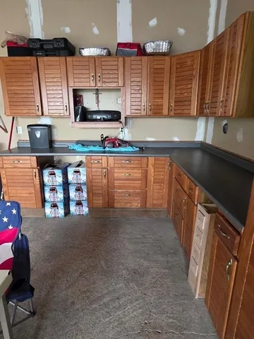 a kitchen with stainless steel appliances a sink stove and cabinets