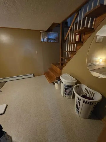 a water heater room with wooden floor