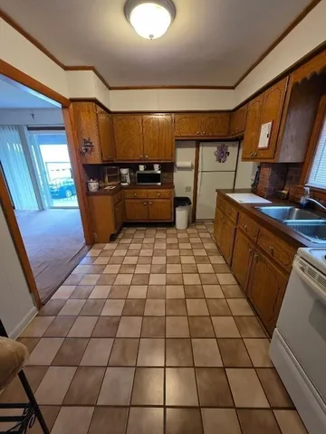 a kitchen with a sink a stove and a shower