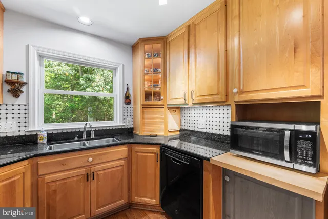 a bathroom with a shower a sink and a mirror