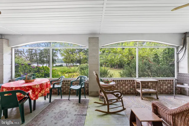 a view of a lake with a bench and trees