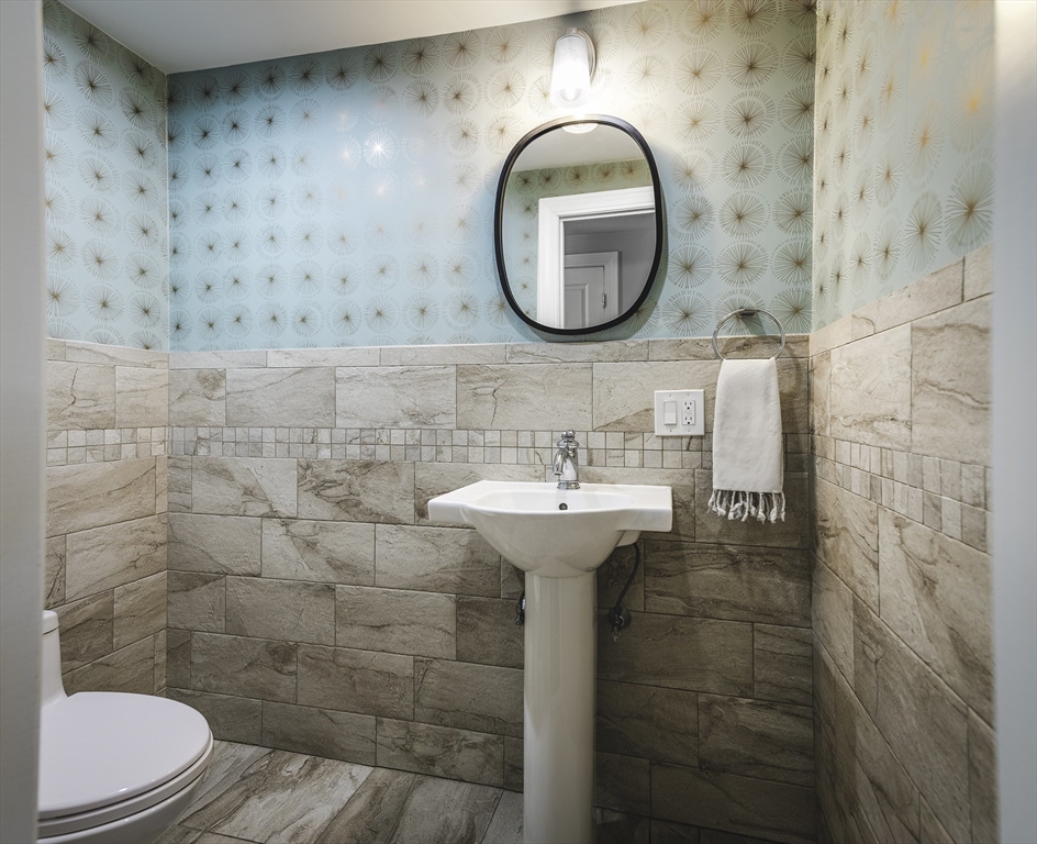 176 Hale Street Beverly, MA 01915 - Photo 13 of 41 a bathroom with a sink a mirror a toilet and a shower