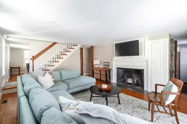 a living room with furniture a fireplace and a flat screen tv