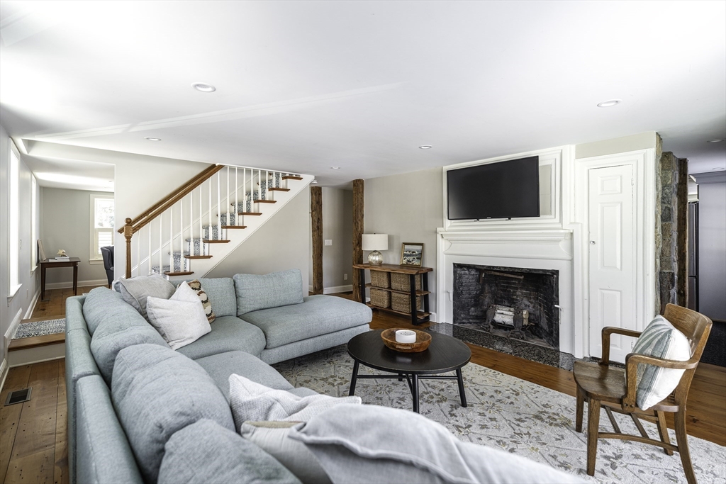 176 Hale Street Beverly, MA 01915 - Photo 14 of 41 a living room with furniture a fireplace and a flat screen tv