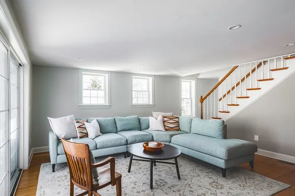 a living room with furniture and a potted plant on table