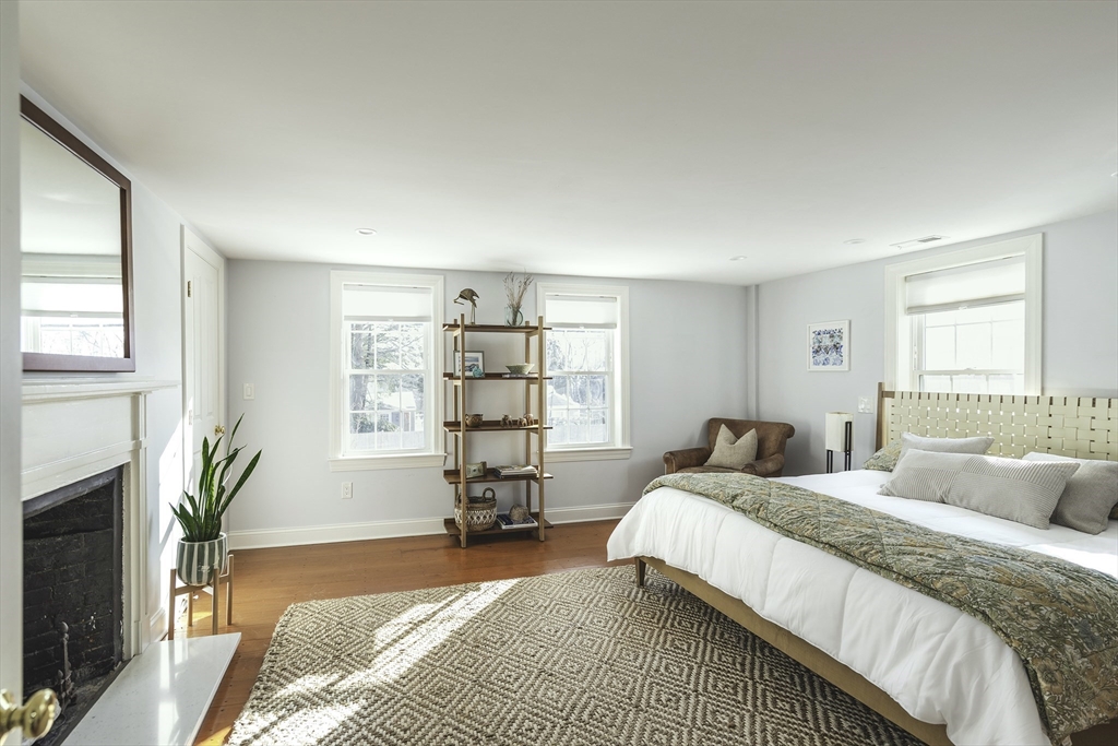 176 Hale Street Beverly, MA 01915 - Photo 21 of 41 a spacious bedroom with a bed a window and potted plant on the dresser