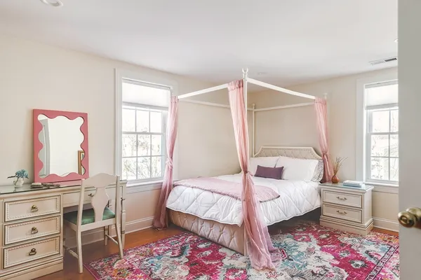 a bedroom with a bed a table and chair