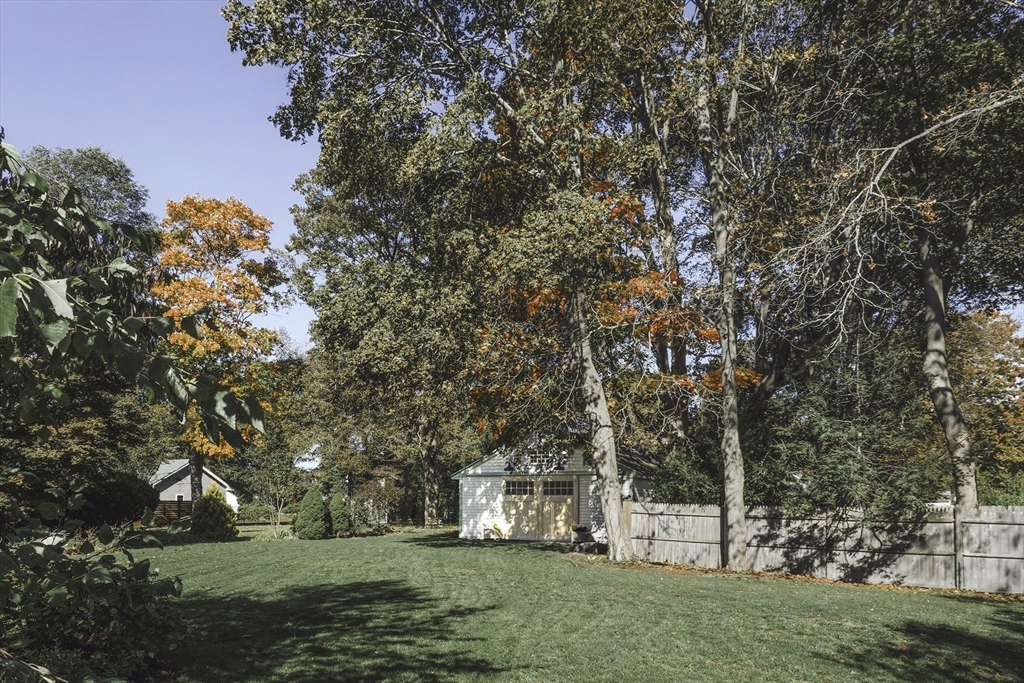 176 Hale Street Beverly, MA 01915 - Photo 29 of 41 a view of a white house with a big yard and large trees