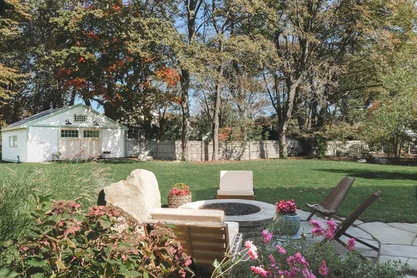 a view of a house with backyard sitting area and garden
