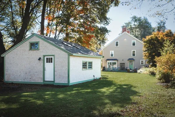 a front view of house with yard and green space
