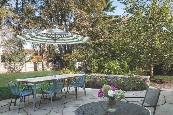 a view of a house with backyard sitting area and garden