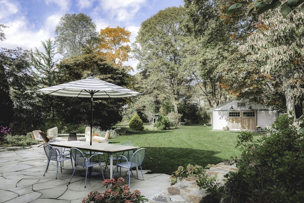 176 Hale Street Beverly, MA 01915 - Photo 37 of 41 a view of backyard with table and chairs under an umbrella