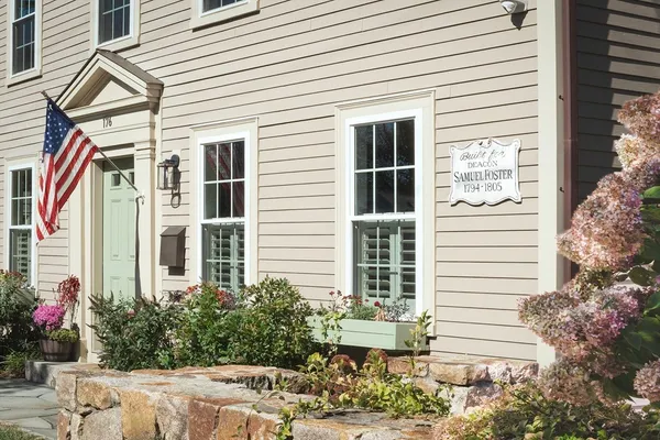 a view of a house with backyard sitting area and garden