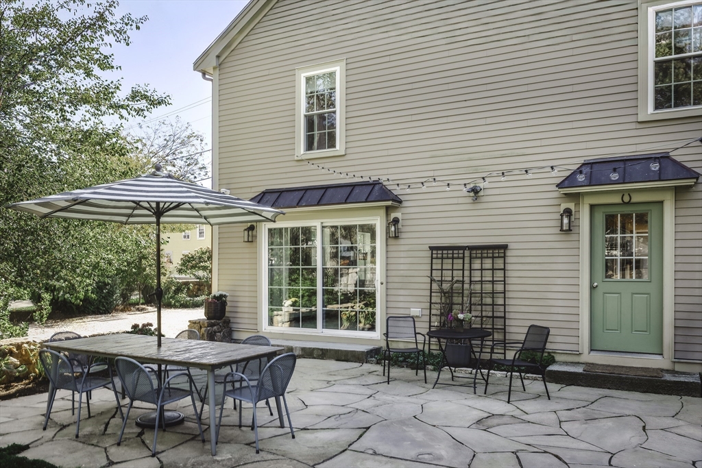 176 Hale Street Beverly, MA 01915 - Photo 4 of 41 a backyard of a house with a table and chairs