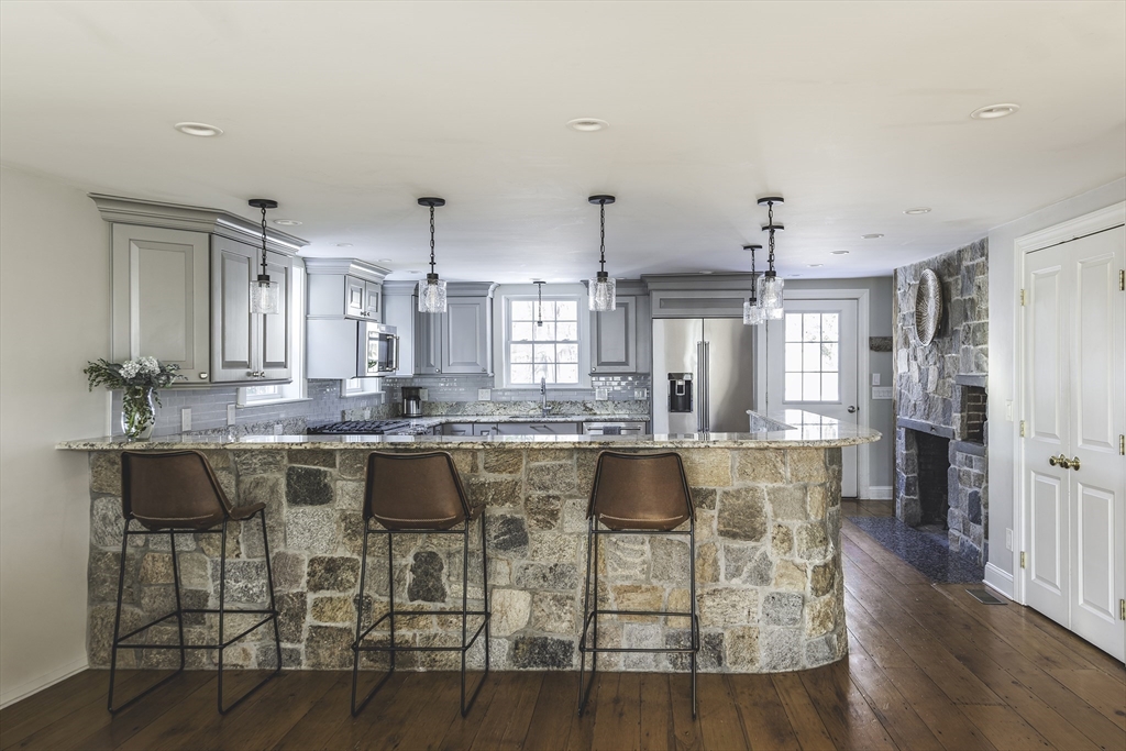 176 Hale Street Beverly, MA 01915 - Photo 6 of 41 a kitchen with stainless steel appliances granite countertop a dining table chairs and granite counter tops