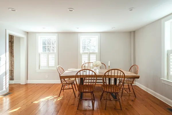 a view of a dining room with furniture window and wooden floor