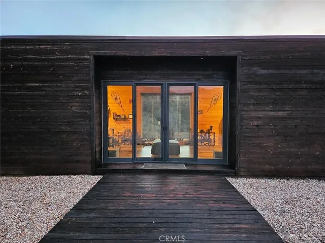 a view of empty room with wooden floor and a fireplace
