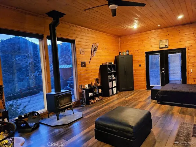 a bedroom with furniture and wooden floor