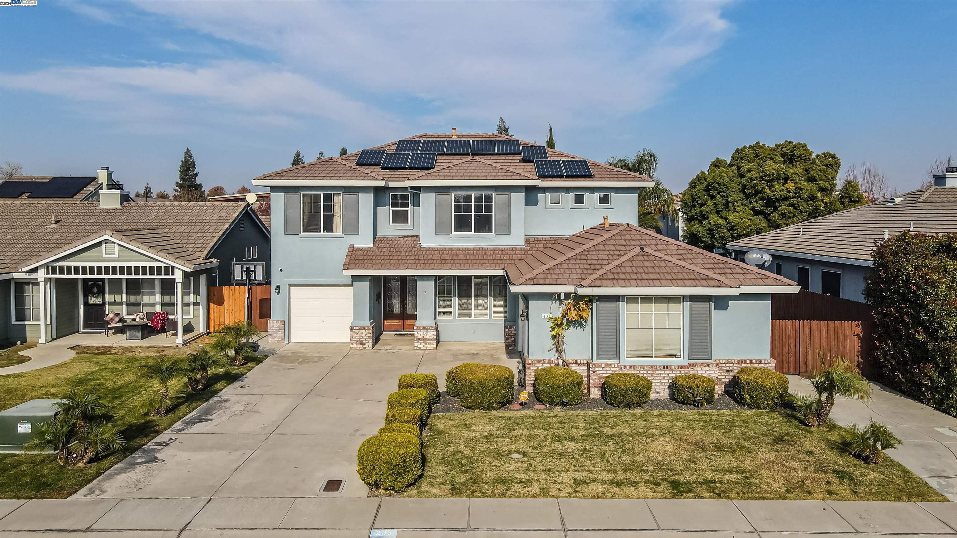 233 Osborne Court Ripon, CA 95366 - Photo 1 of 1 a front view of a house with garden