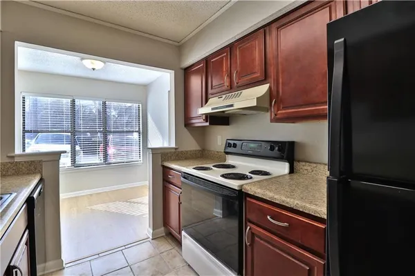 a kitchen with stainless steel appliances granite countertop a stove and a refrigerator