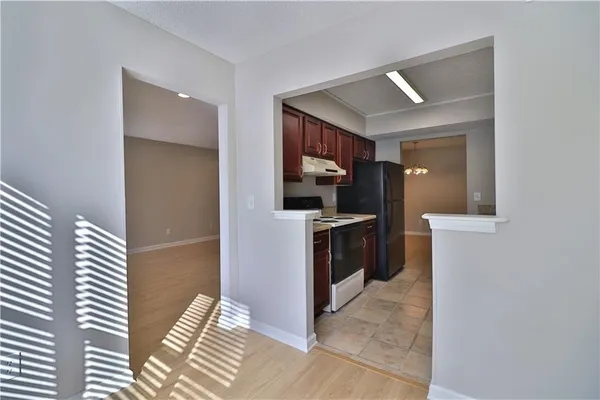 a kitchen view with granite countertop a sink and a stove top oven