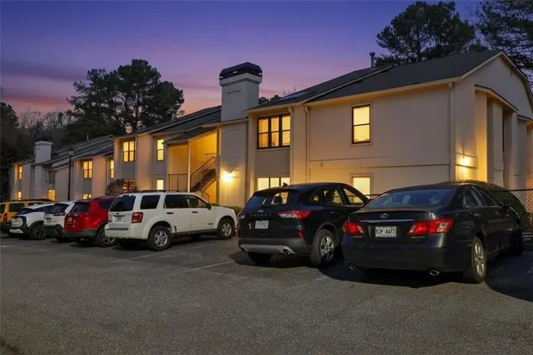 a couple of cars parked in front of a house
