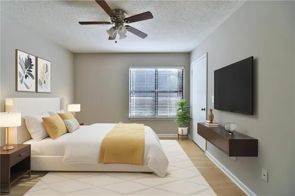 a bedroom with a bed and a flat screen tv