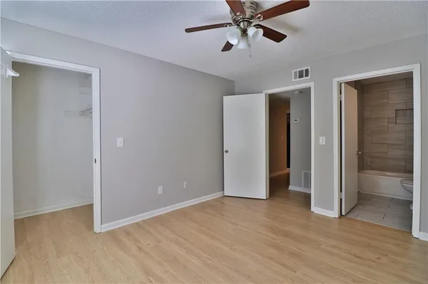 wooden floor in an empty room with a bathroom