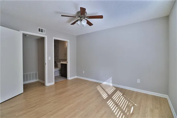 a view of room with wooden floor and ceiling fan
