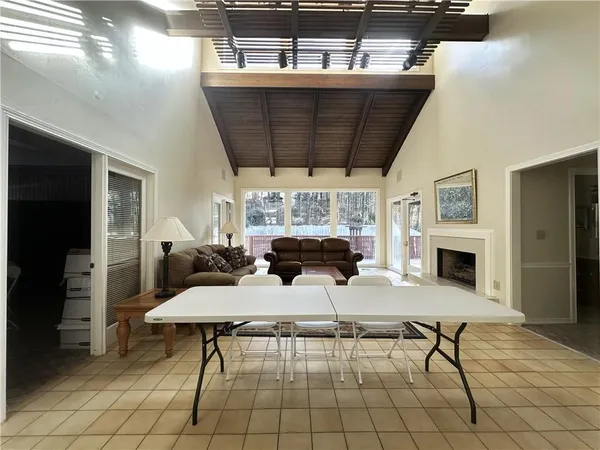a living room with furniture a fireplace and a table