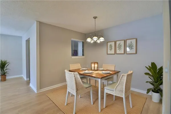 a view of a dining room with furniture and chandelier